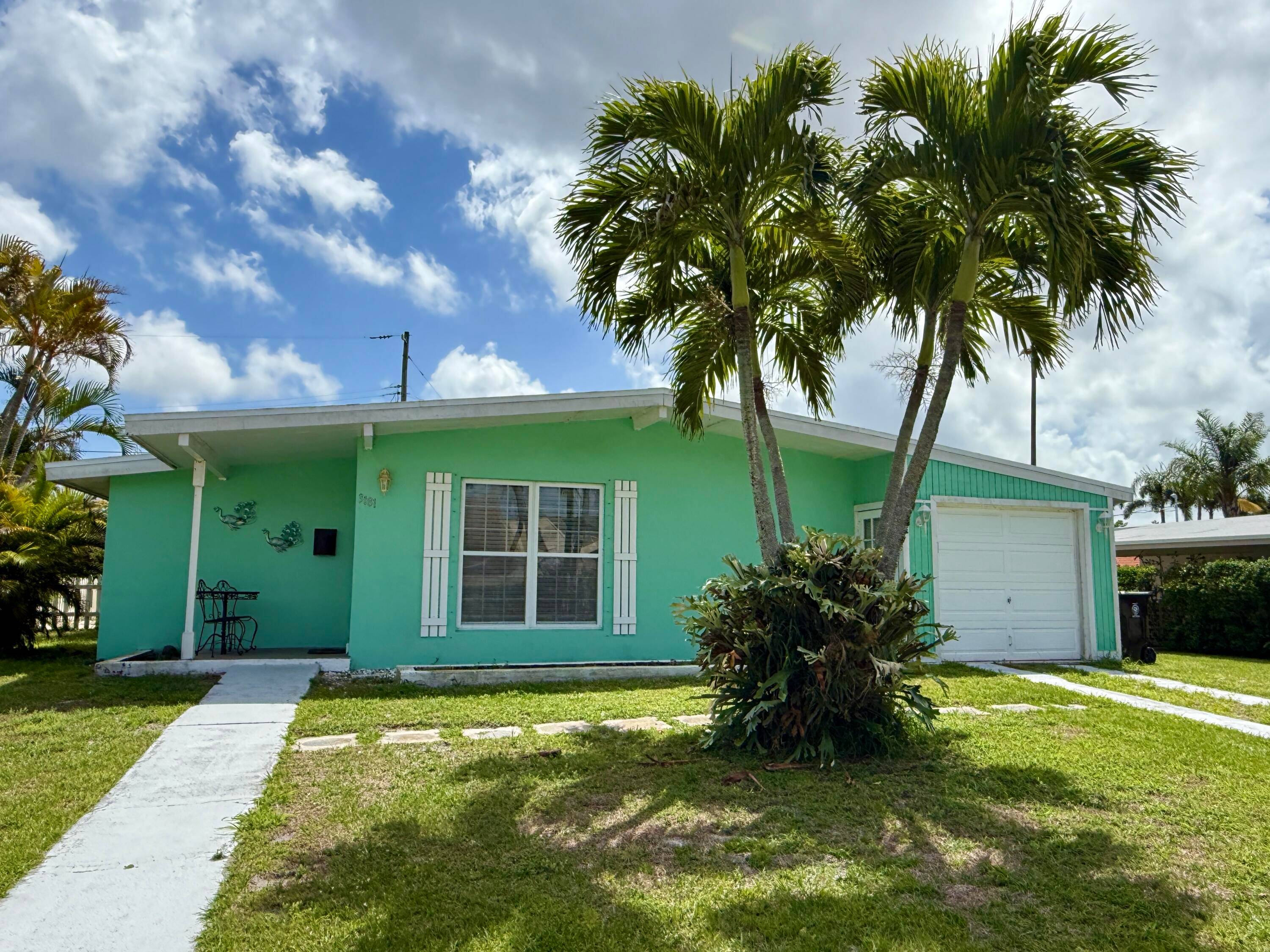 Adorable updated cottage with 1 car garage tucked back in Sandpiper Bay area.