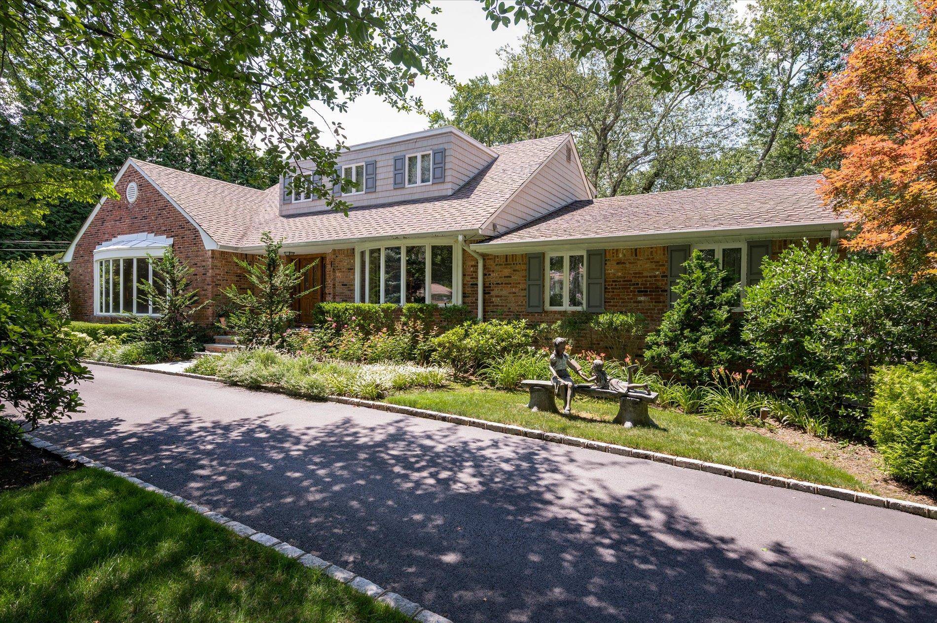 Welcome to 14 Pine Drive, a stately 4 bedroom, 6 bathroom residence nestled in the prestigious Hunting Hill community of Woodbury.