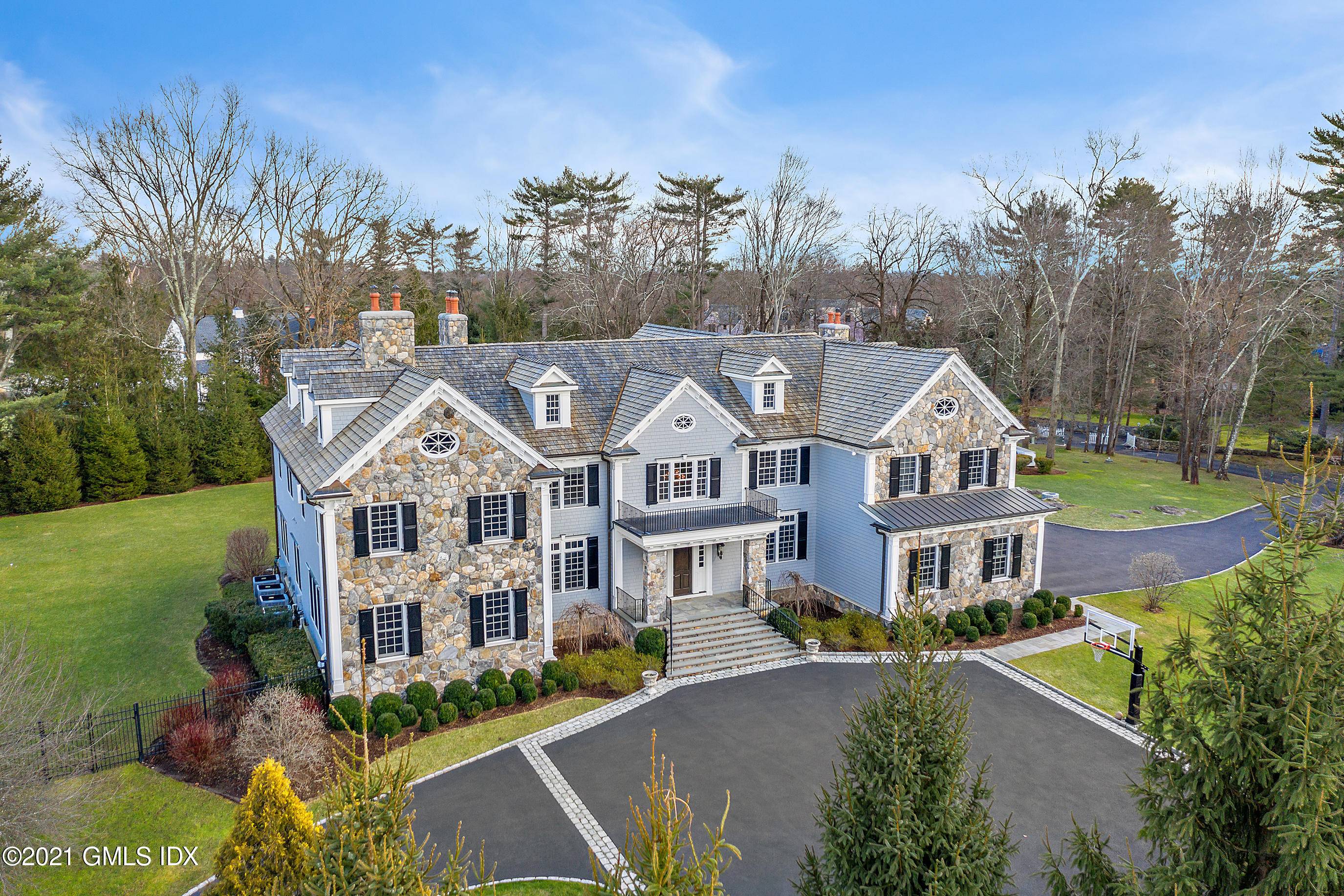 Majestic Georgian Colonial perfectly sited at the apex of an elevated 2 acre property situated within a private association in a prime Greenwich ''mid country'' location off Lake Avenue.