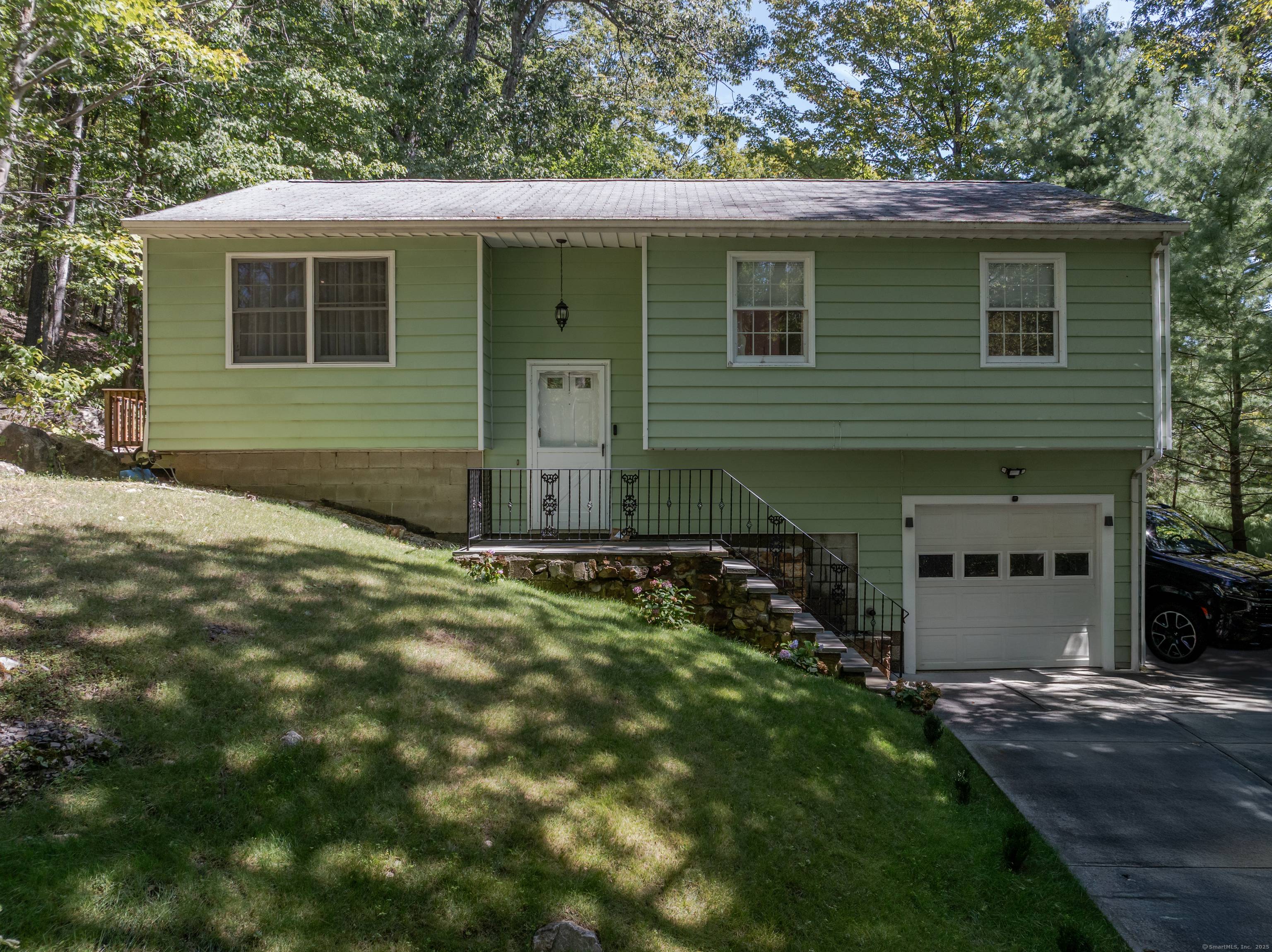 Beautifully renovated 3BR 2BA Raised Ranch featuring gleaming hardwood floors throughout the living room, dining area, hallway, and bedrooms.