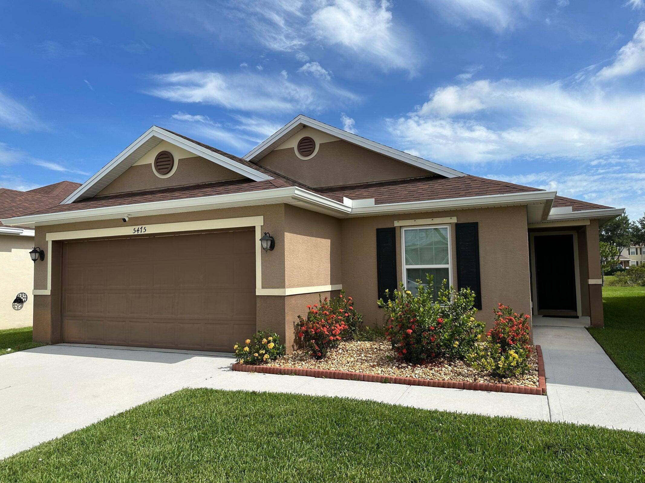 This home offers a seamless open layout, connecting the living room, dining area, and kitchen for easy living.
