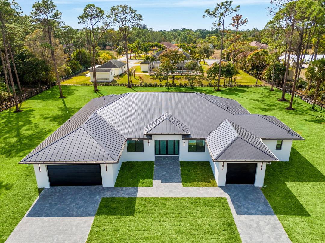 Welcome to elevated living in Loxahatchee where luxury meets privacy on a PAVED ROAD with NO HOA.