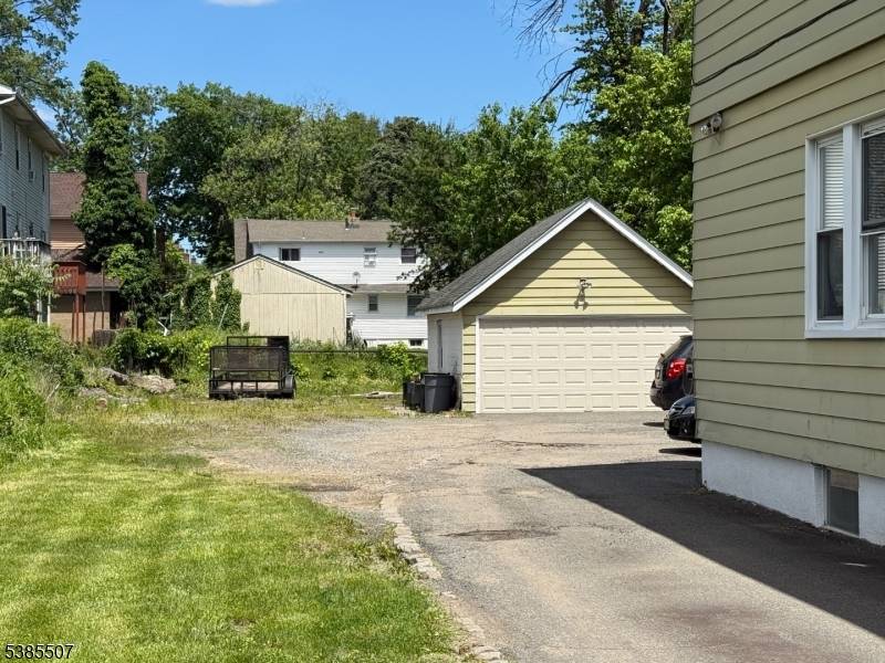 Large legal three family home in Maplewood with oversized detached garage on 60x180 Lot.