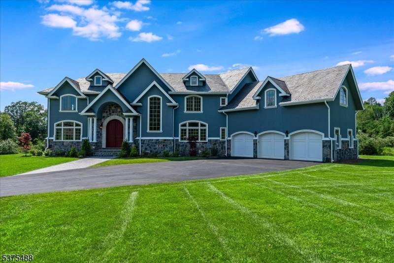 This meticulously designed custom home showcases exceptional quality construction and intricate craftsmanship, featuring extensive millwork throughout.