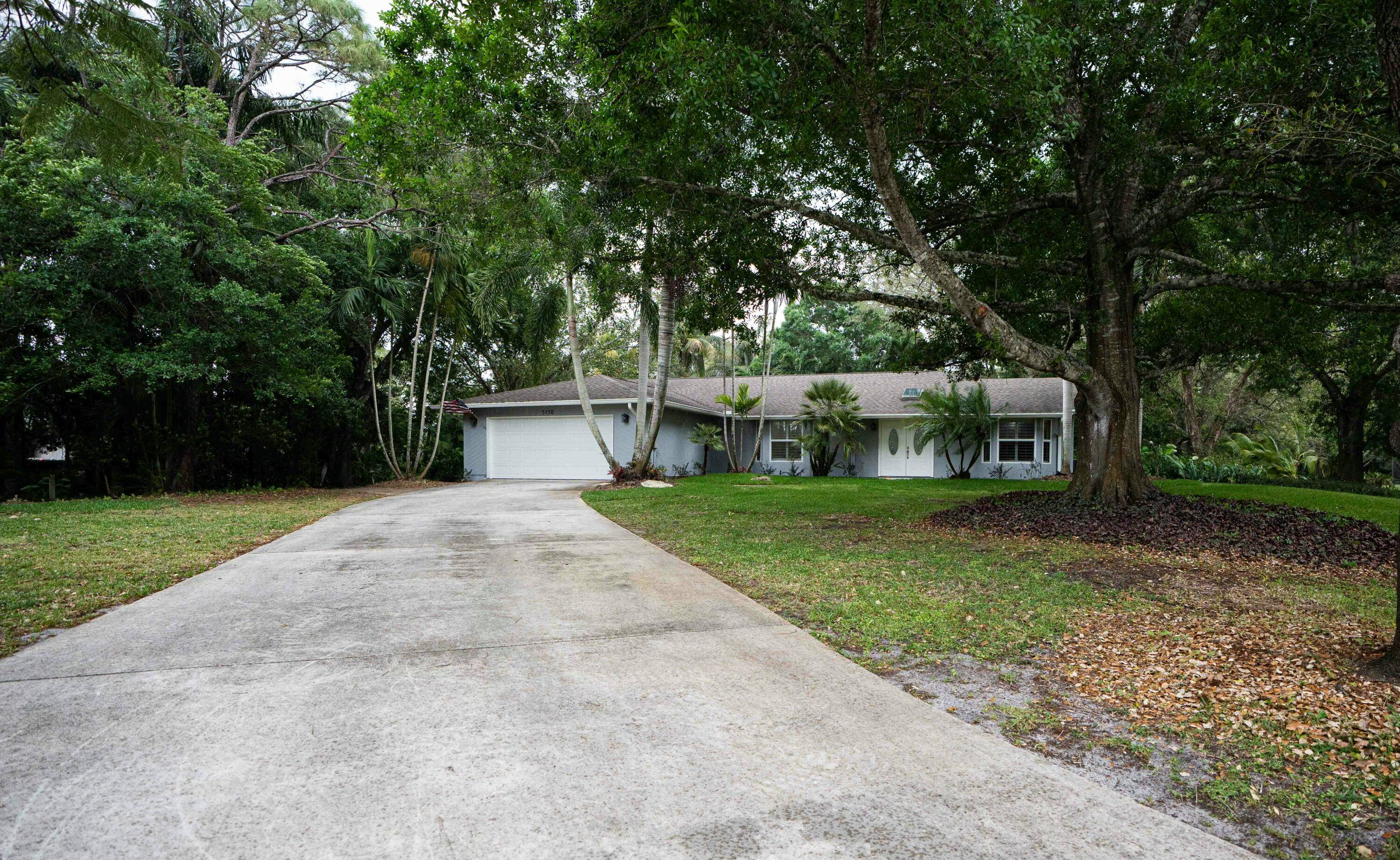 Welcome to 5150 SE Sterling Circle, a beautifully updated pool home nestled on a lush 1.