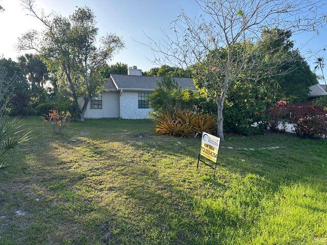 Cozy home nestled on an oversized nature filled corner lot with plenty of room for entertaining and cookouts !