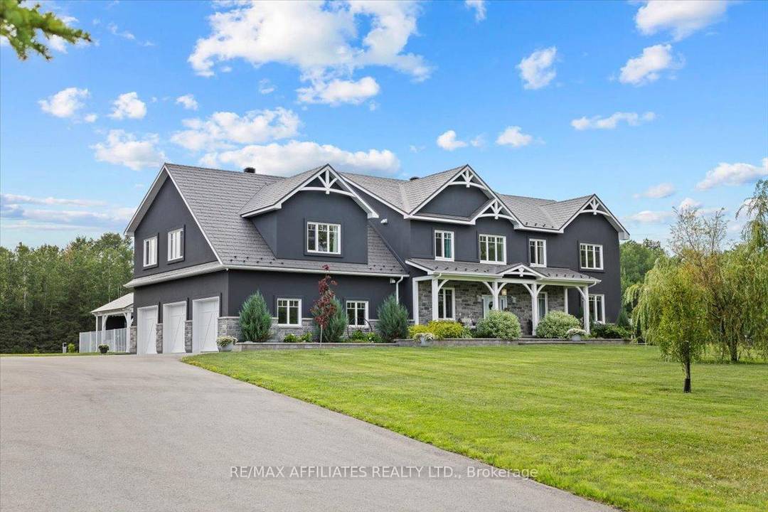 Stunning custom built modern farmhouse on five private acres located in Cumberland, just 10 minutes from Orleans !