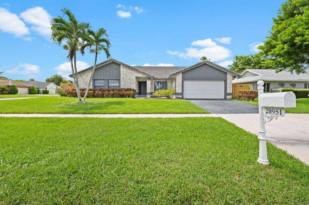Welcome to your beautifully renovated 4 bedroom, 2 bathroom screened pool home located in the sought after Logger's Run community of West Boca Raton.