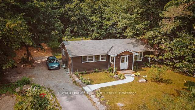 Enjoy year round recreation in this beautifully maintained bungalow nestled on a spacious 300 ft deep lot surrounded by trees.