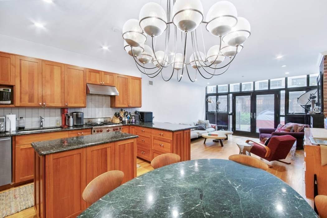 Spectacular owner's triplex with private south facing garden with huge storage shed.