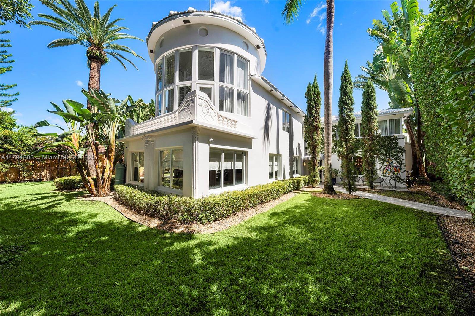 Impeccably renovated, this home in Miami Beach nestled amongst palm trees and 20 ft clusia hedges on prestigious North Bay Road, was designed in the Modern Deco style.