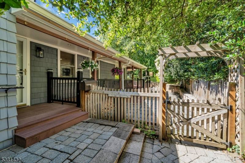 Step inside this beautifully renovated 3 bed 2 bath raised ranch to discover refinished original hardwood floors, a timeless brick fireplace, and modern kitchen and primary bath.