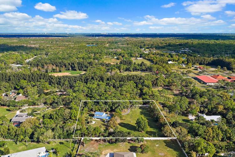 Experience the very best of Jupiter Farms living in this fully remodeled estate home ideally situated on 2.