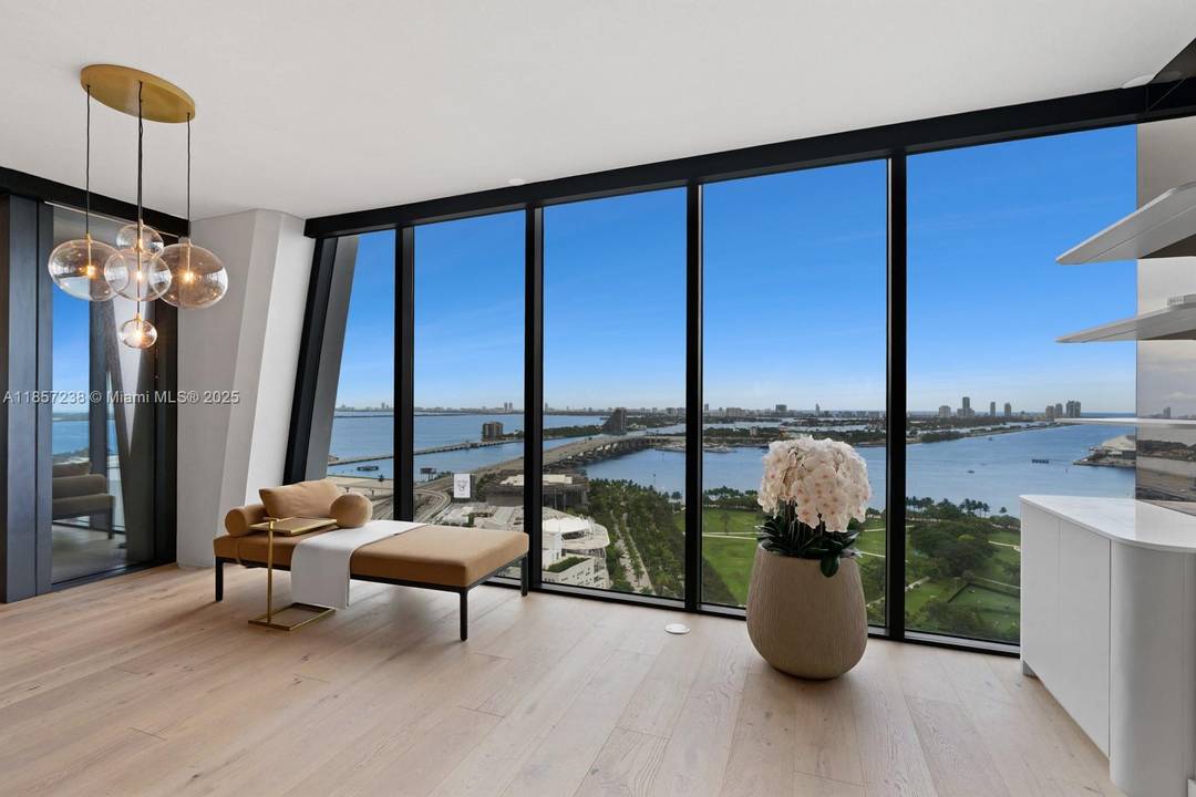 Stunning residence in The One Thousand Unit 2402 offers breathtaking panoramic views of the ocean and city skyline.