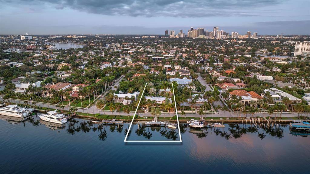 Experience true resort style living on this rare half acre estate in the prestigious gated community of Idlewyld, located just off the iconic Las Olas Blvd.