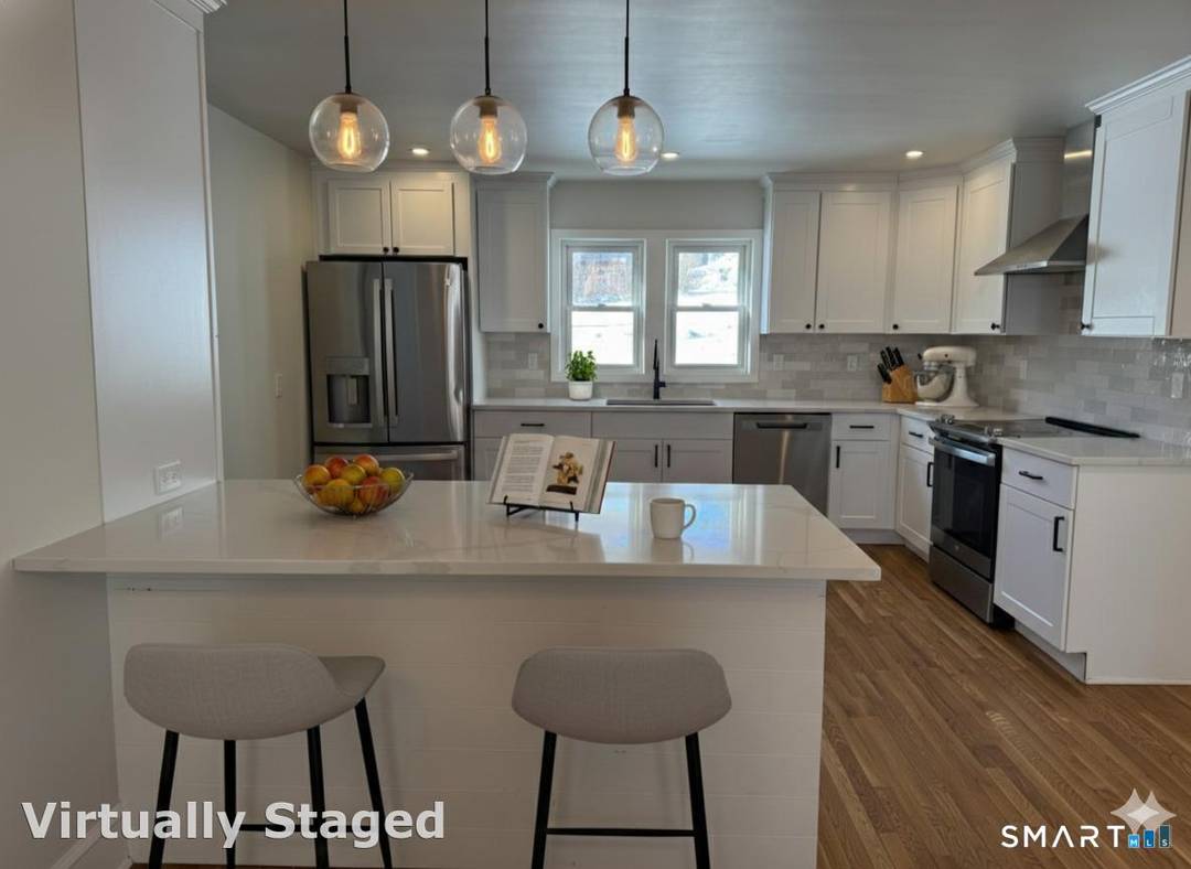 Beautifully refreshed Colonial in the heart of Danbury featuring a modern kitchen with stainless steel appliances and quartzite countertops, a main level full bath, new roof, 200 amp electrical service, ...