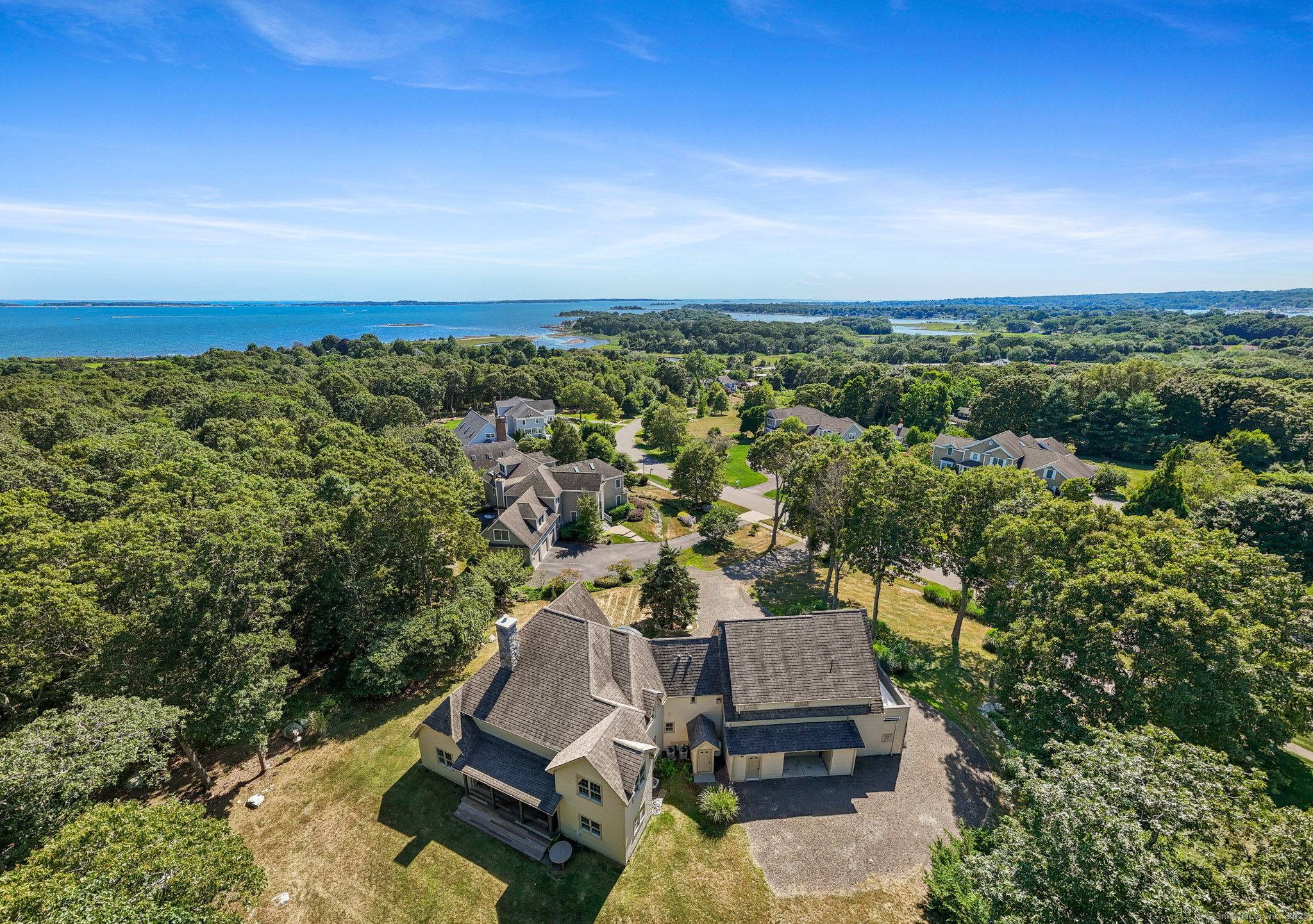 Come experience a stunning contemporary country style home, beautifully sited on a hillside with panoramic views stretching across Mystic River Valley to water views of Fishers Island Sound.