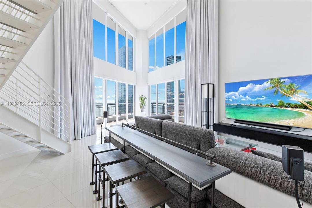 This stunning two level corner unit boasts three bedrooms, three baths, plus a powder room, offering breathtaking panoramic views of the Miami skyline, city, bay, and ocean from every room.