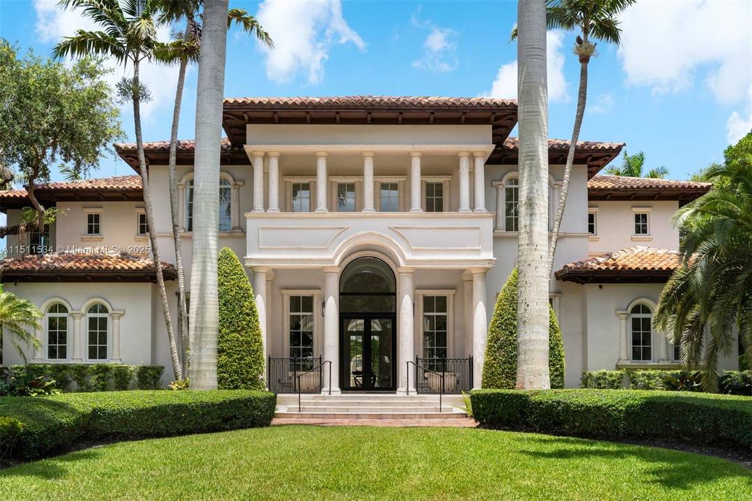 Luxury estate on esteemed Suburban Dr in Pinecrest, boasting a through lot design.