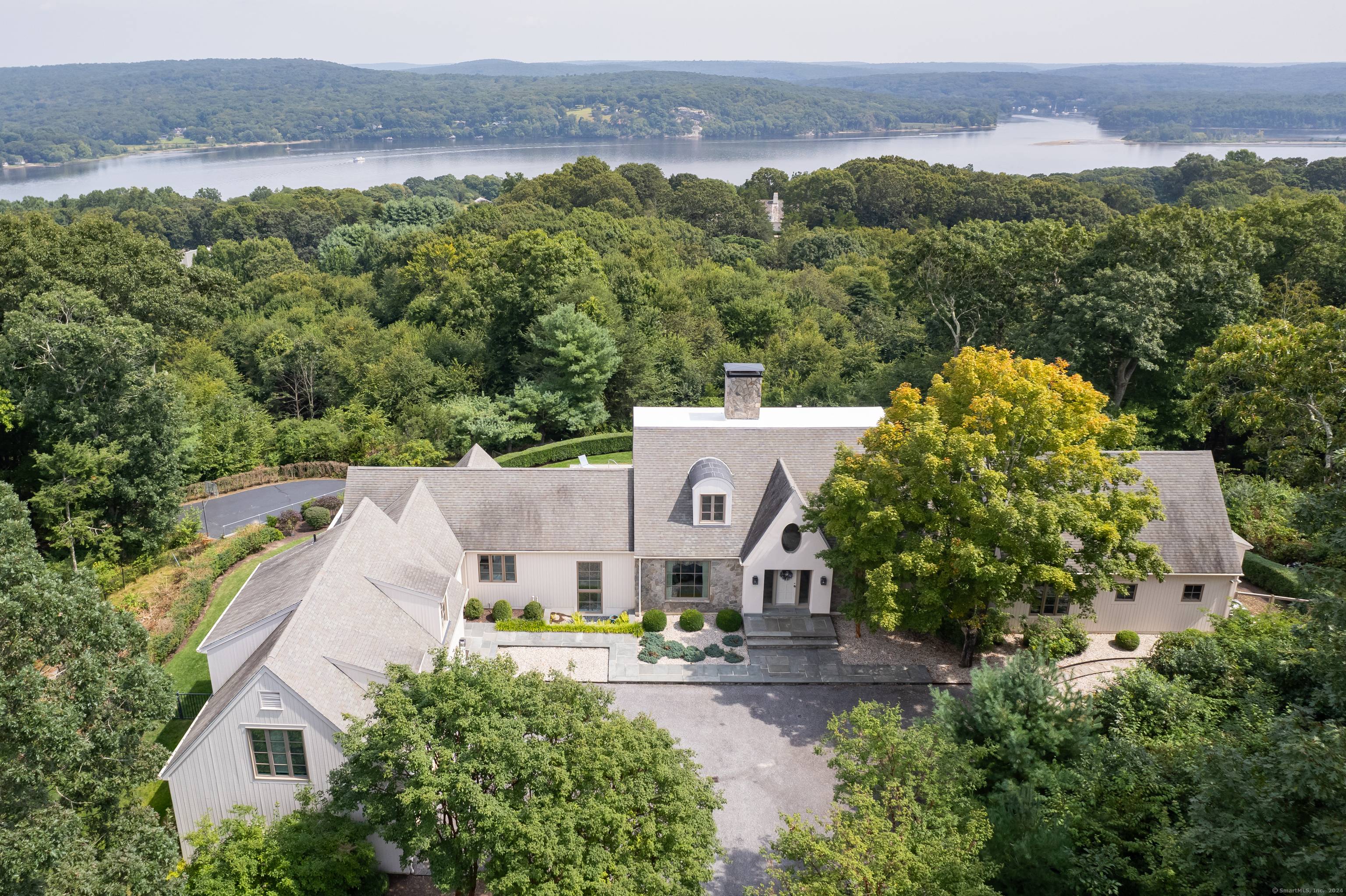 Offering privacy without seclusion the epitome of coastal living awaits from this extraordinary residence with expansive views of the Connecticut River, Lyme Hills, Hamburg Cove and beyond.