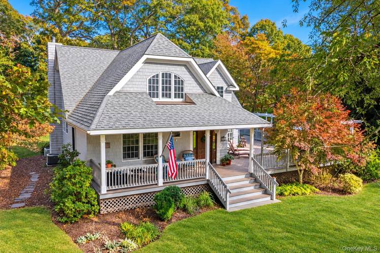 Stylish and comfortable home with plenty of space to relax indoors and out, featuring a covered porch, a sunny deck and a large yard.