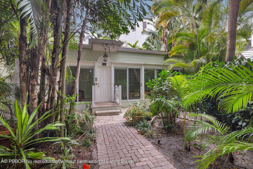 Tucked away in the heart of Palm Beach, this quintessential island bungalow is a rare jewelbox, offering privacy, charm, and effortless indoor outdoor living.