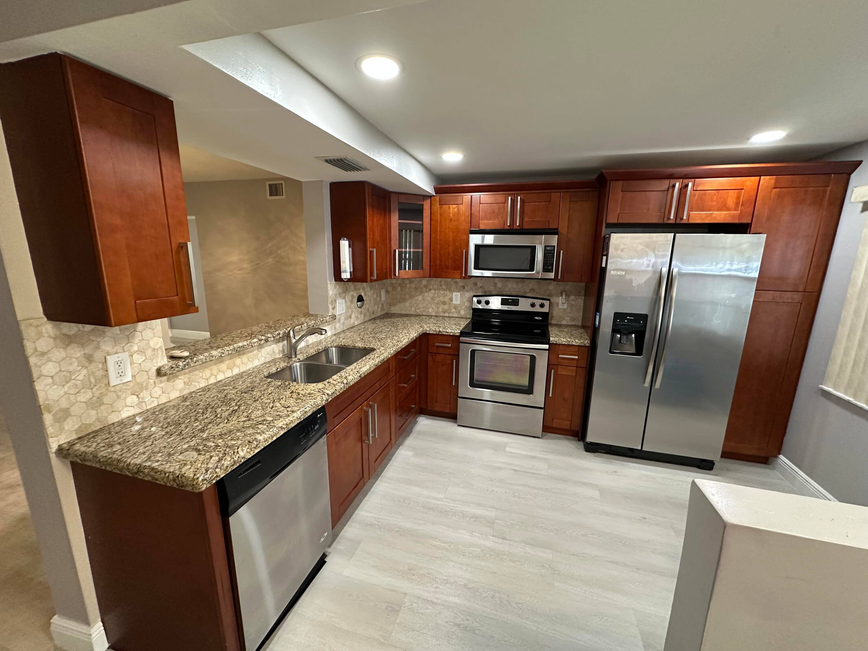 Beautiful two bedroom two bath ground floor condo in the amazing over 55 community of Wynmoor.