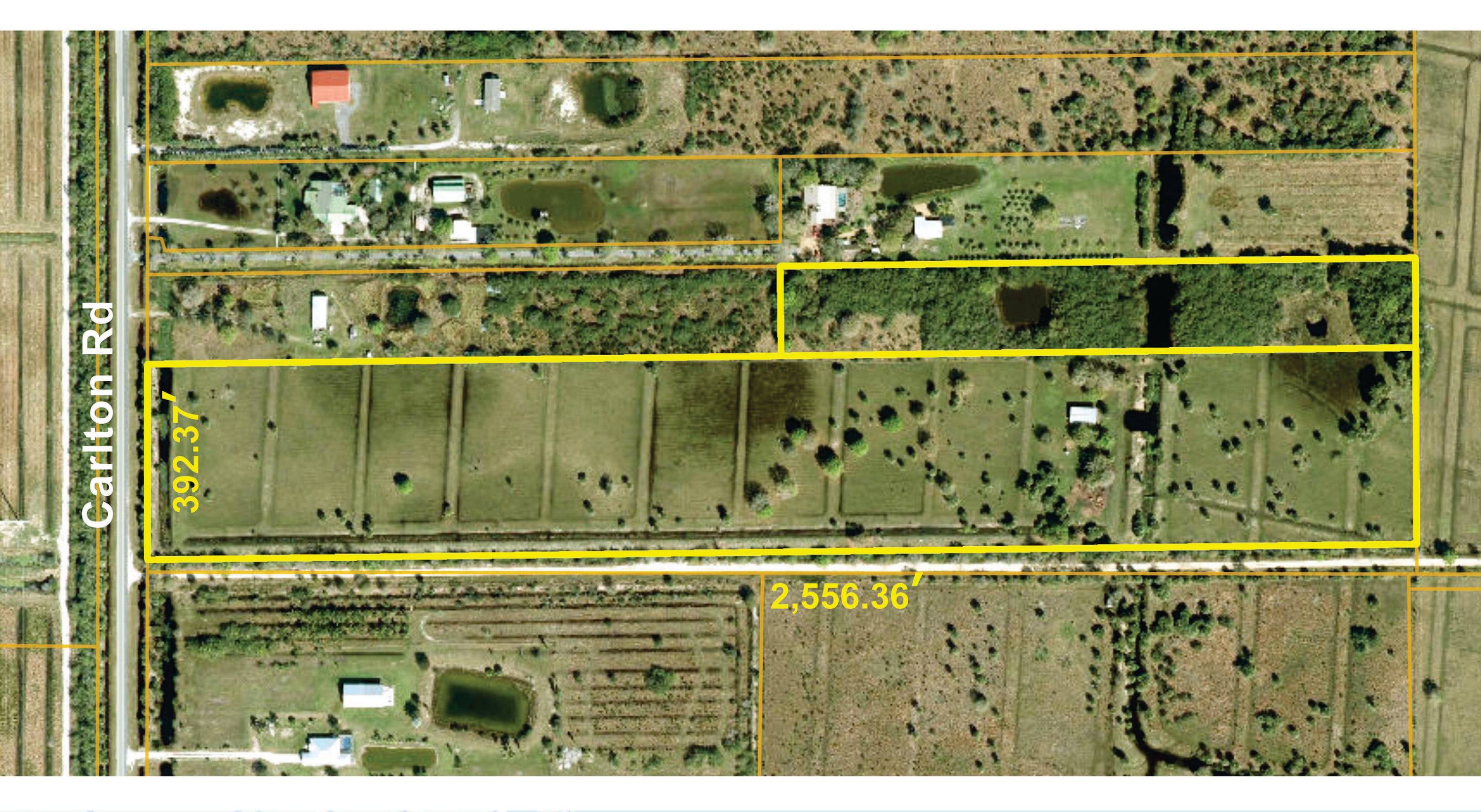 Two adjacent parcels, the larger one with 392 ft paved frontage on Carlton Rd.