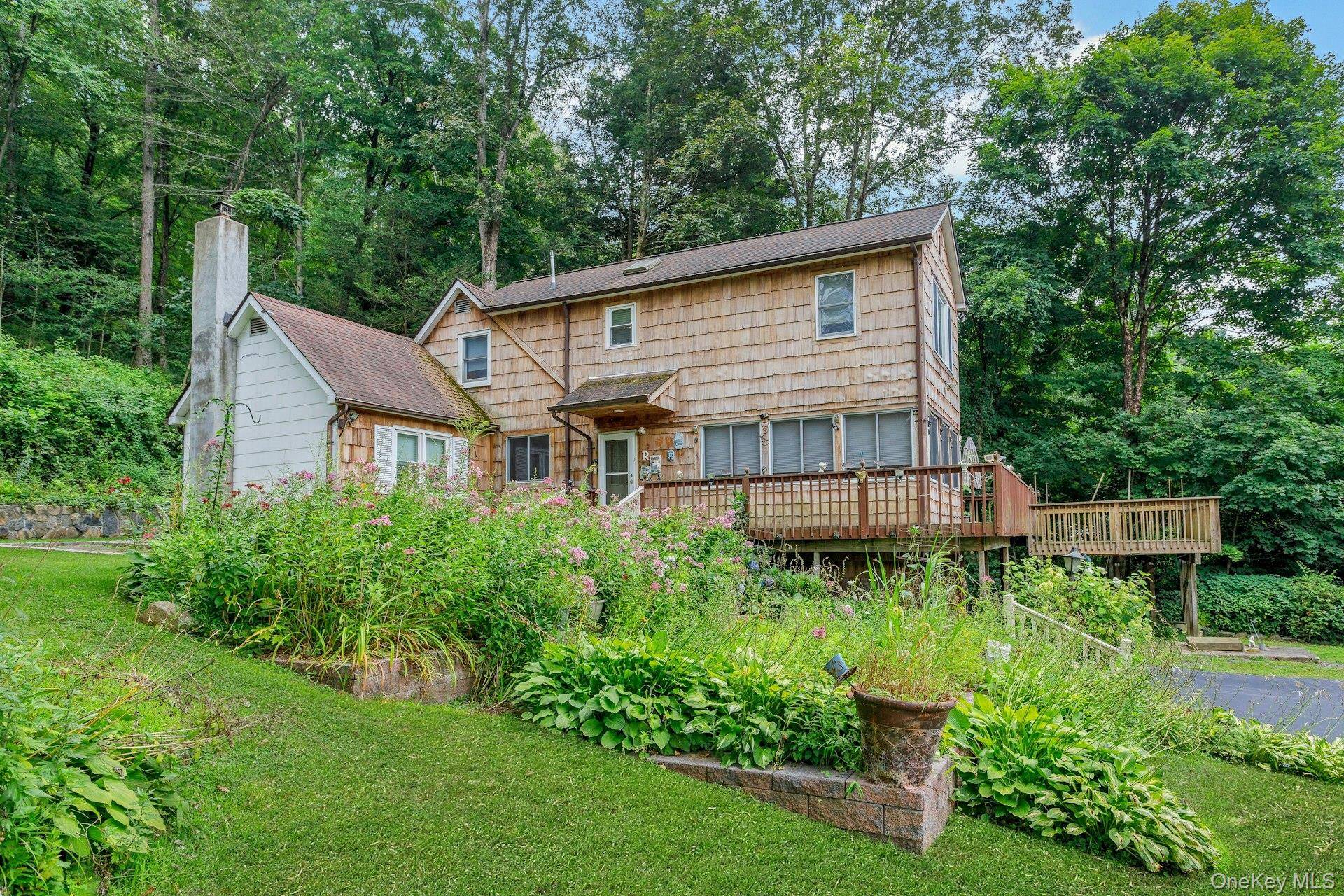 Welcome to this expanded Cape Cod home, set back from the road and surrounded by nature, offering a rare blend of privacy and charm.