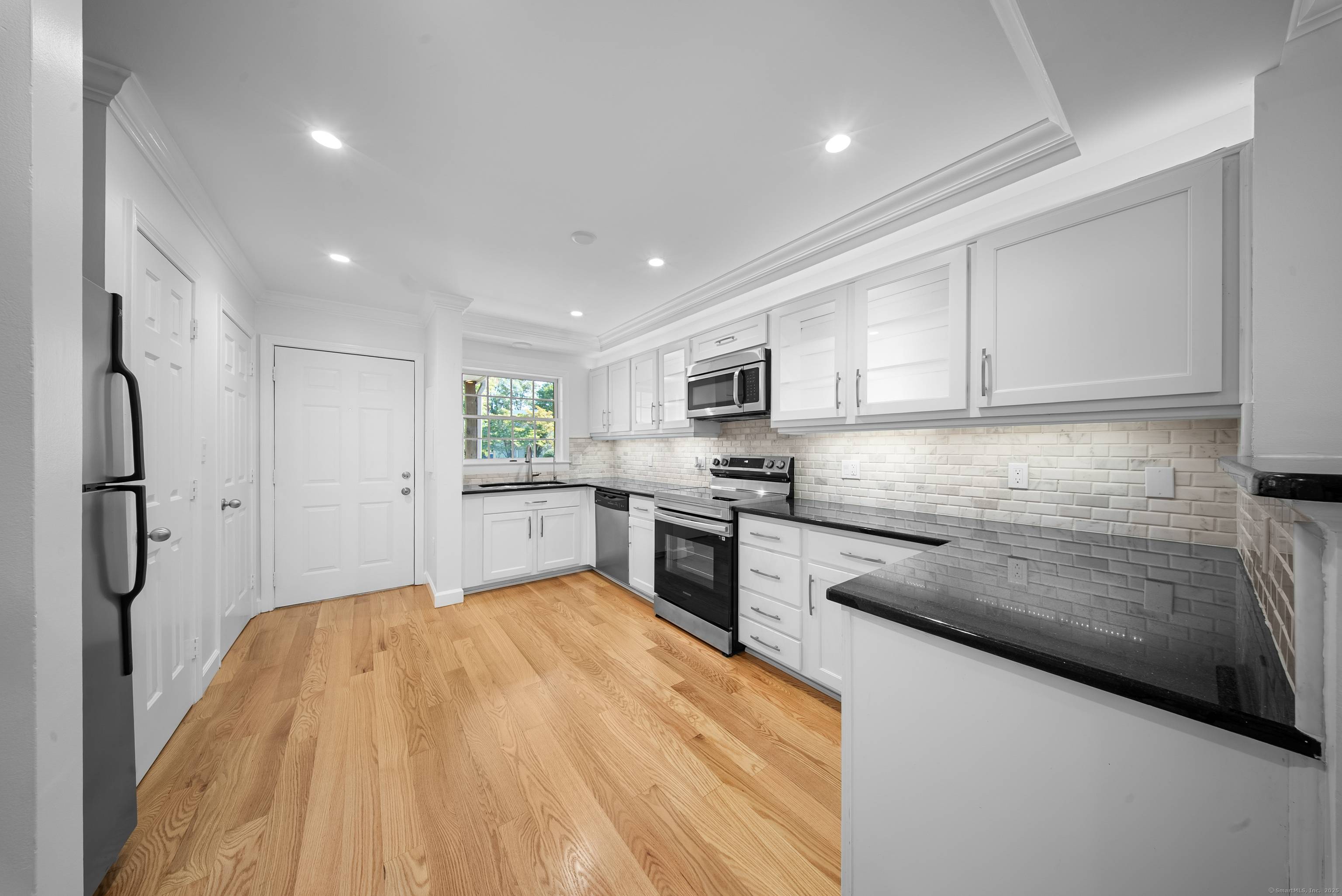 Beautifully updated end unit townhouse featuring hardwood floors throughout, an open concept kitchen and living room, a private balcony and two assigned parking spaces.