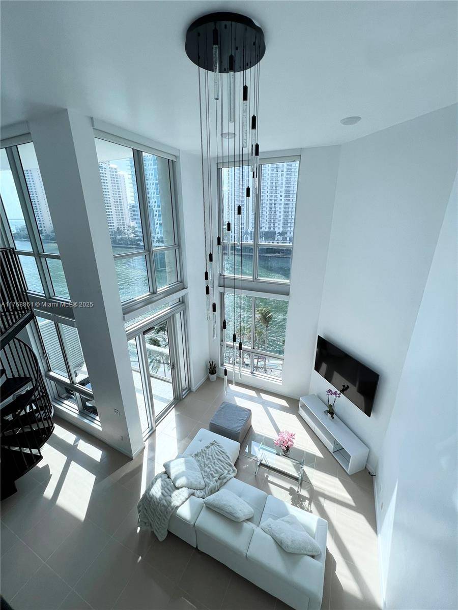 Experience luxury waterfront living in this high end furnished two story 1 bedroom Loft at MET1 with 20 ft ceilings and expensive floor to ceiling windows with stunning WATER views ...