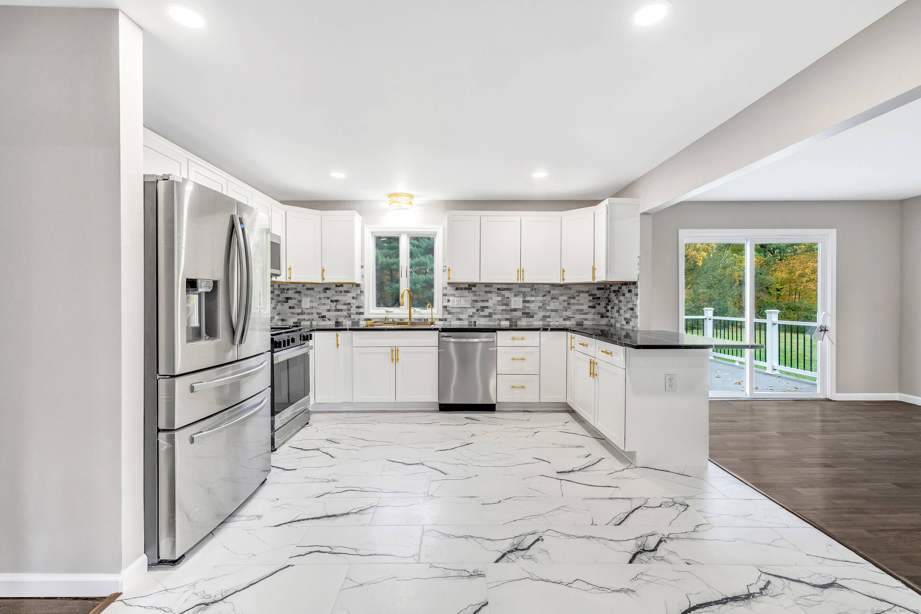 Welcome home to this stunning, completely renovated expanded raised ranch !