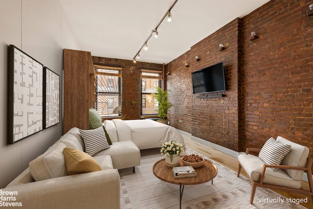 Charming East Village Condop Studio with Exposed Brick Bohemian chic studio on a coveted tree lined block in one of downtown's most desirable neighborhoods.