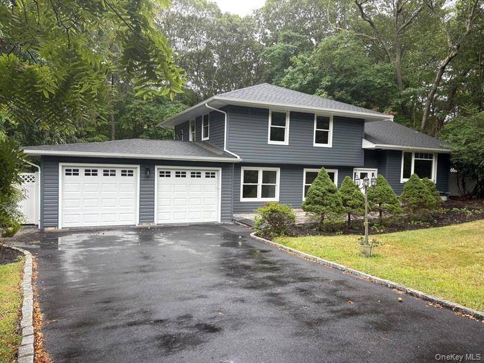 This beautifully updated home features a new roof, central air conditioning, siding, gutters, doors, and garage door, along with a brand new deck, paver patio, and driveway.