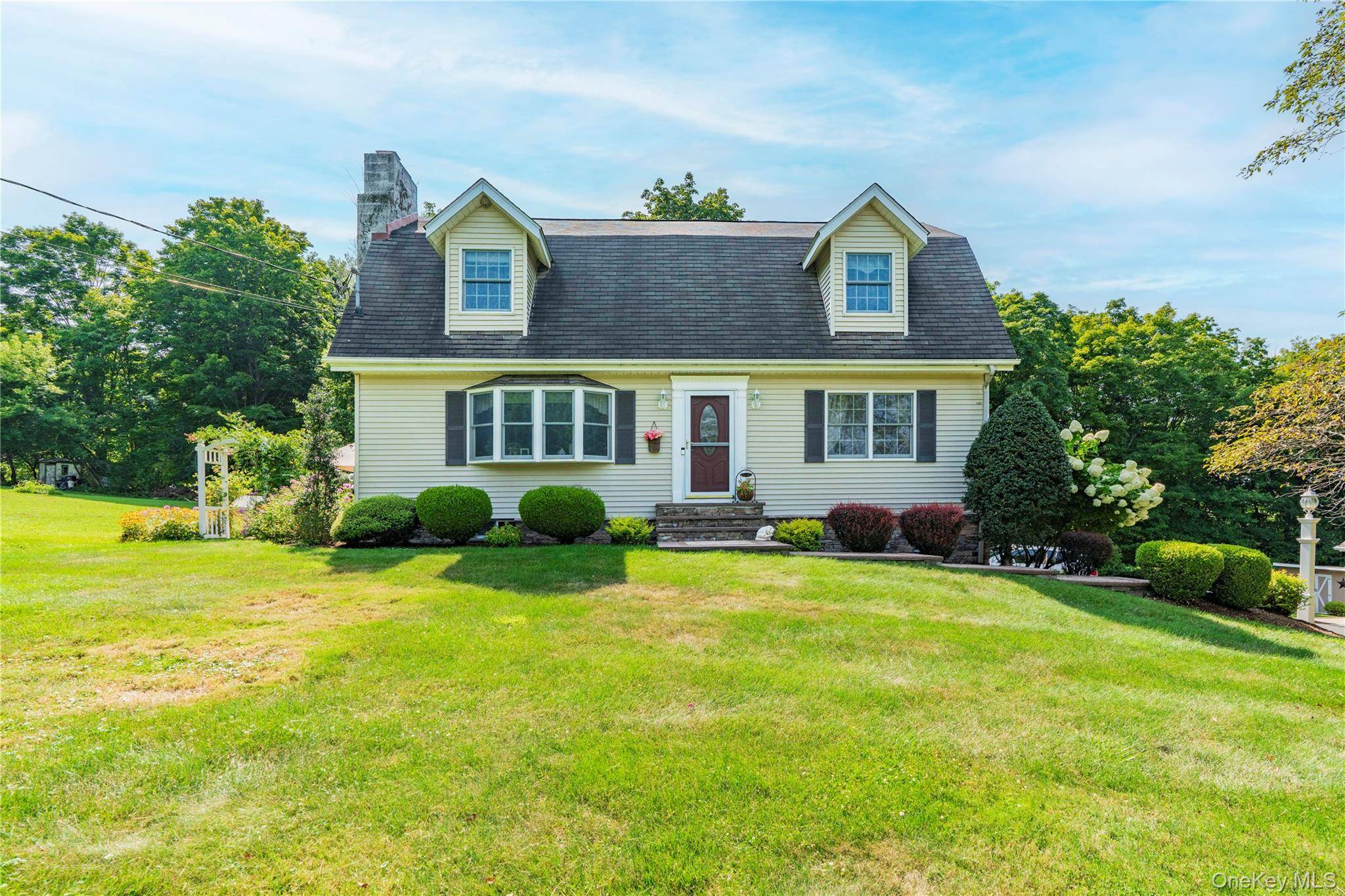 Welcome to this charming Cape Colonial style home, perfectly set on a private and impeccably maintained 1.