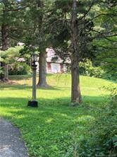 Center hall colonial in a beautifully natural private setting.