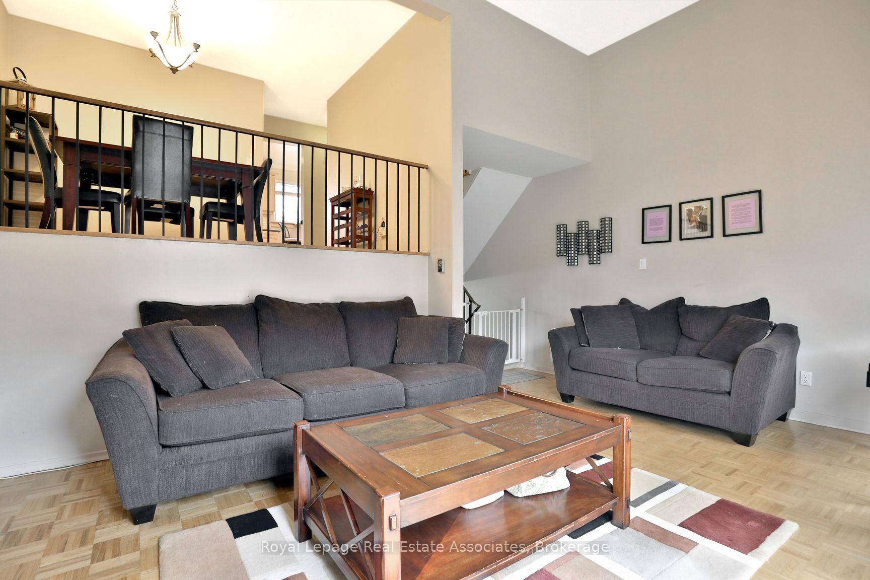 This spacious and charming home features a large living room with soaring ceilings, creating a grand atmosphere.