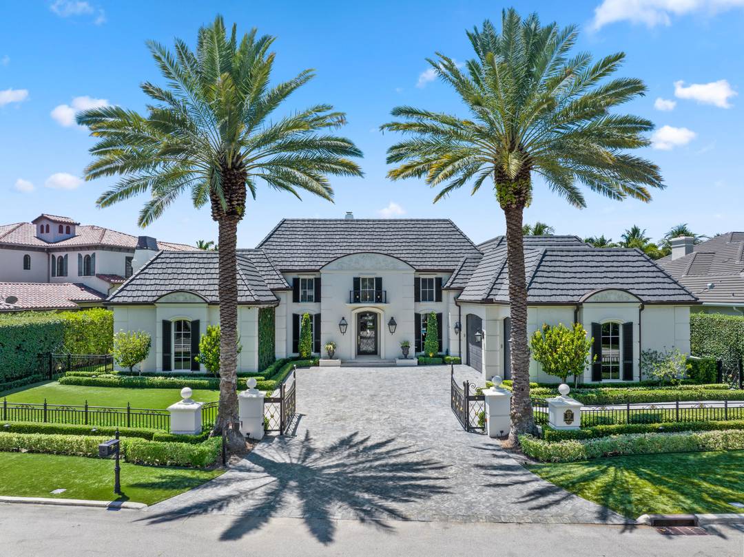 An Elegant French chateau style residence in the prestigious Royal Palm Yacht Country Club.