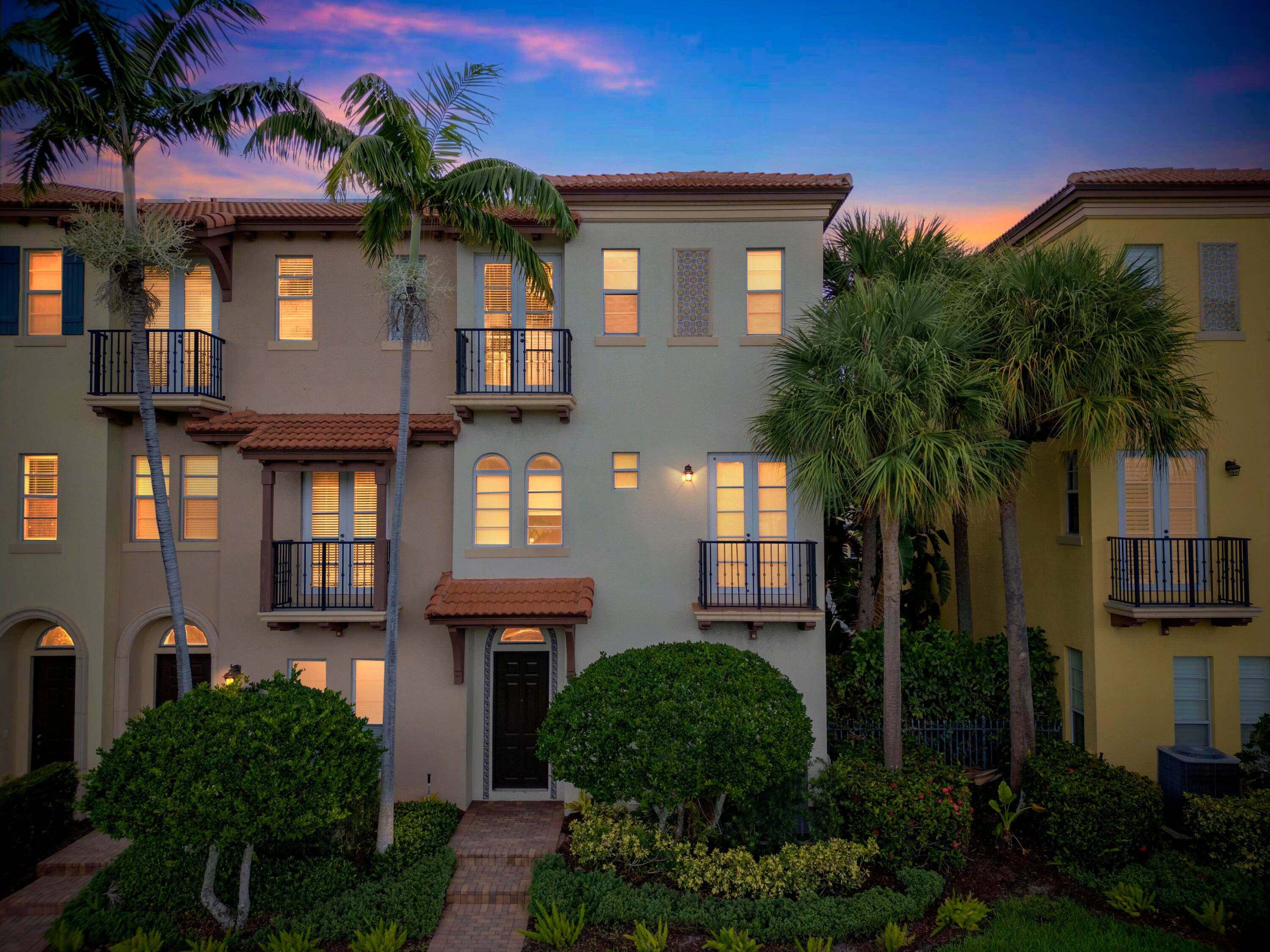Highly Upgraded Luxurious corner townhome in the lush gated community of Royal Poinciana in East Boca Raton.