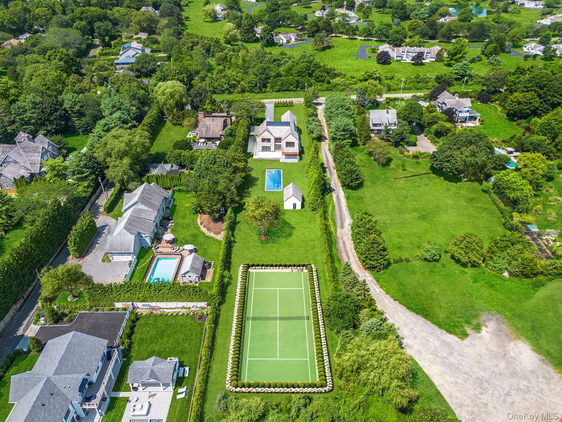 Tucked behind a curtain of privacy hedges and located south of the highway in Southampton Village, 50 Tuckahoe Lane is a stunning brand new construction set on 1.