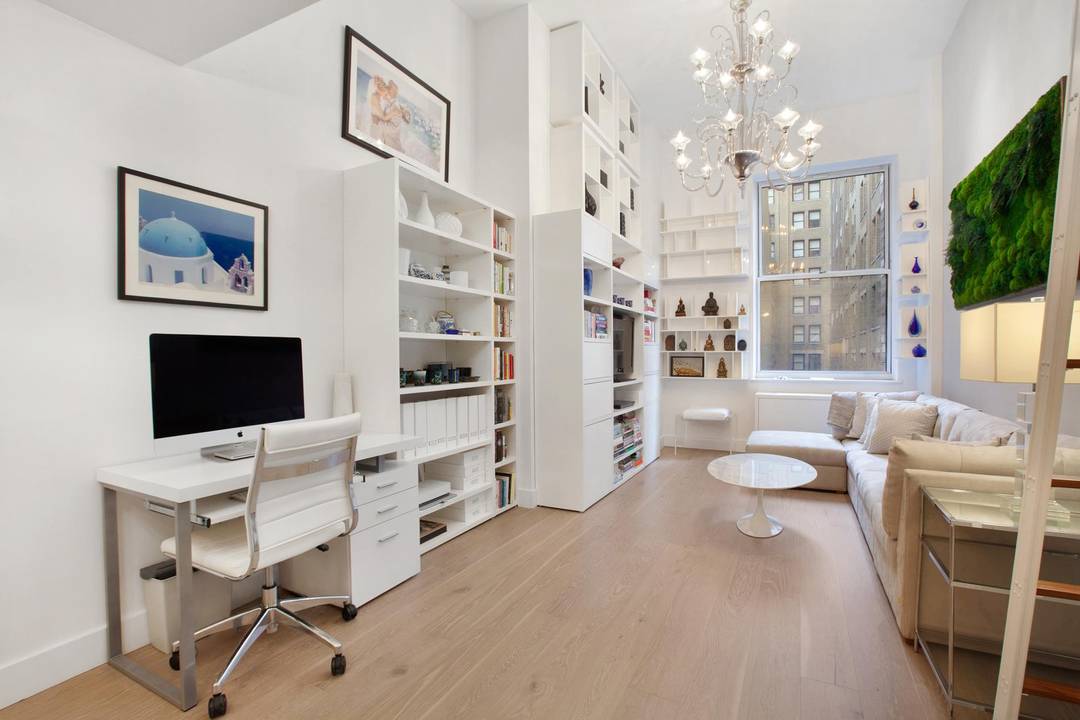 Fully gut renovated studio loft at the landmark Downtown Club lives like a true one bedroom, with soaring 14 foot ceilings, a custom sleeping loft, a dedicated home office, and ...