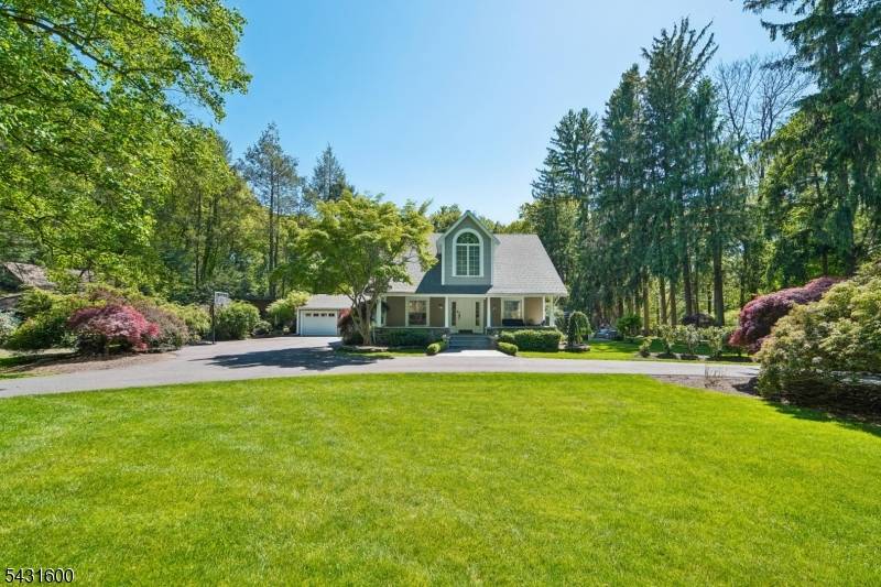 42 Hillside is a modernized early 1900s front porch Colonial set on an expansive parklike setting of 1.
