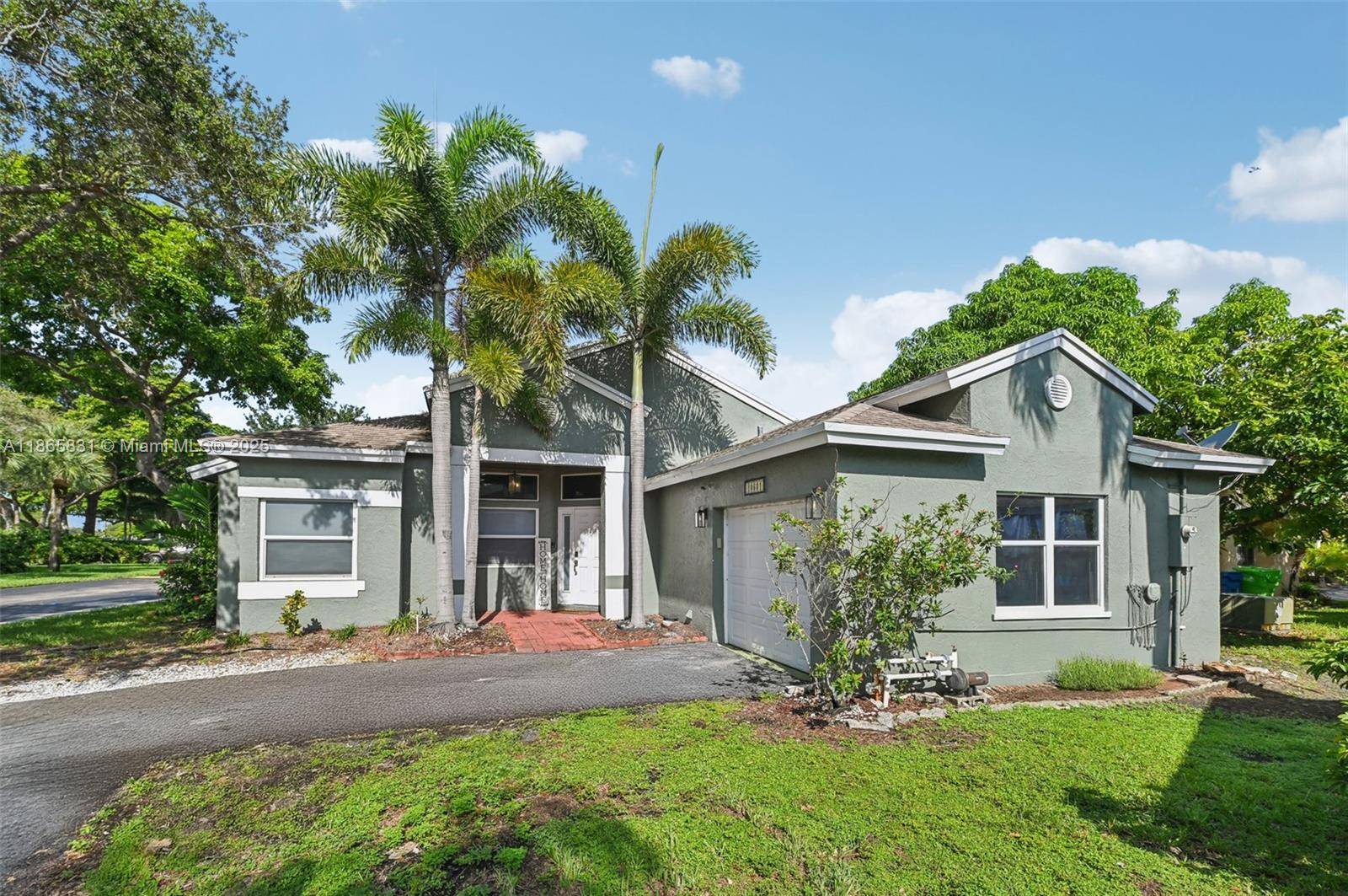 Beautifully remodeled 3BR 2BA home with an open floorplan, vaulted ceilings, LED lighting, pale gray laminate flooring, remote blinds, and impact windows doors.