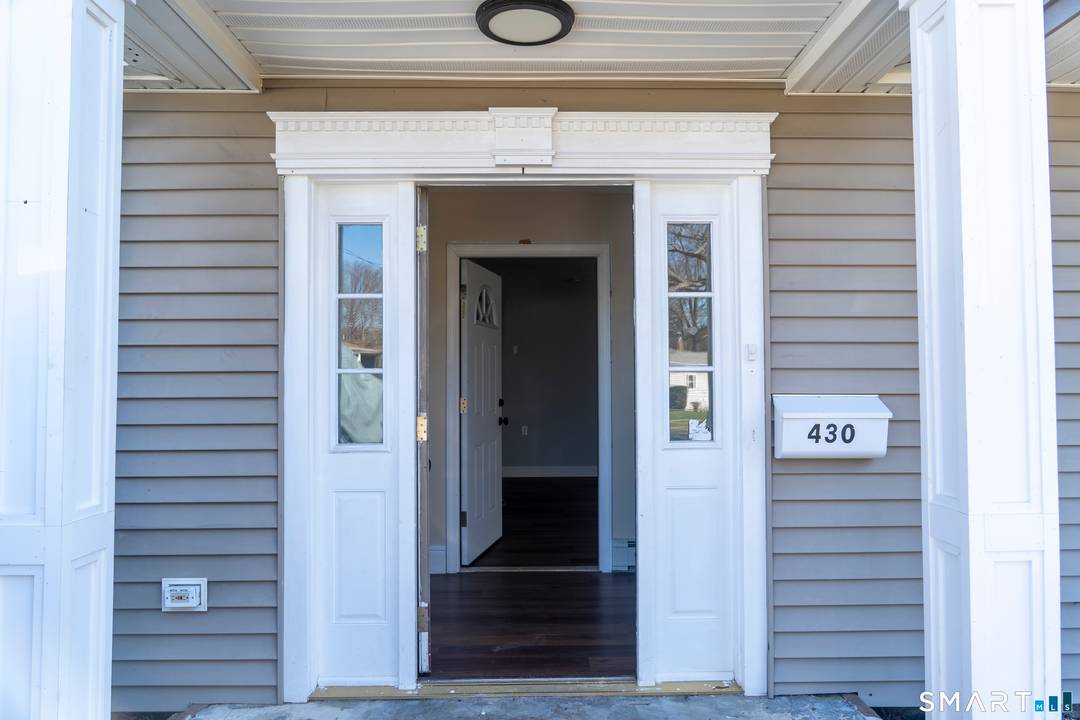 Beautifully renovated ranch on a quiet street, offering a spacious main living area with a kitchen featuring subway tile, stunning custom cabinets, granite countertops, and a large center island with ...