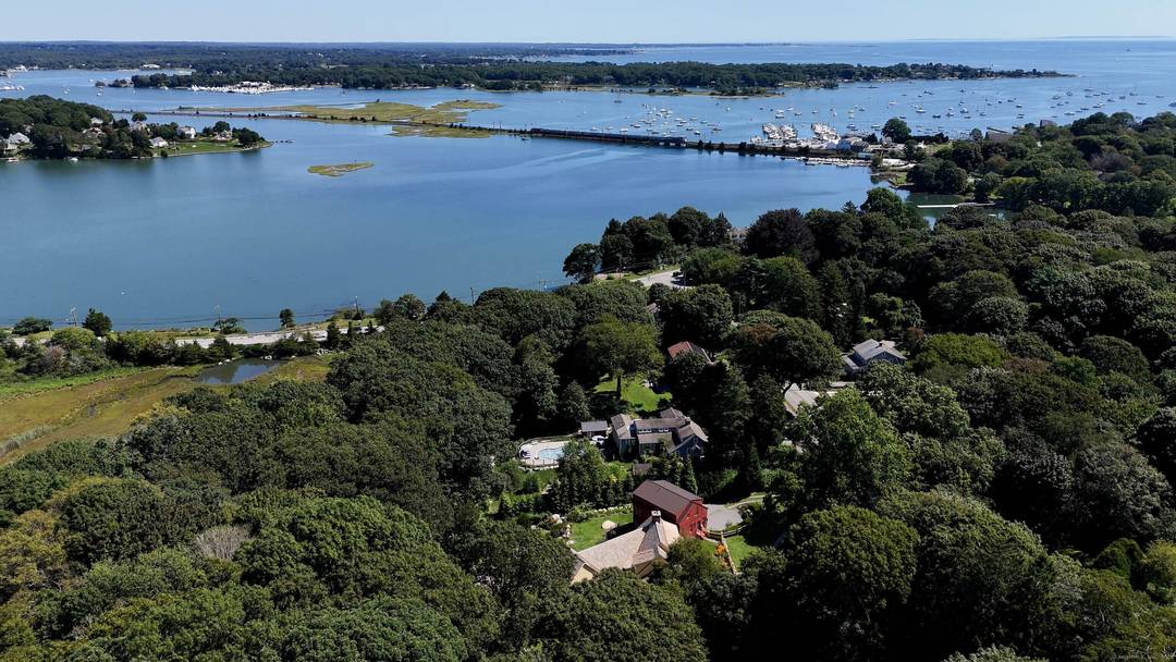 Set along a coveted stretch of the New England coastline with views of the Mystic River Long Island Sound, this coastal Noank, CT estate is a masterclass in cape style ...