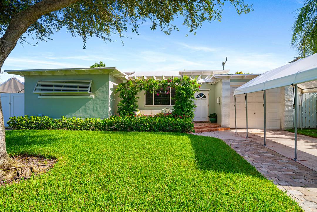 Mid Century Modern Charmer in coveted SoSo ; east of Olive Avenue on a desirable through street to the Intracoastal Waterway.