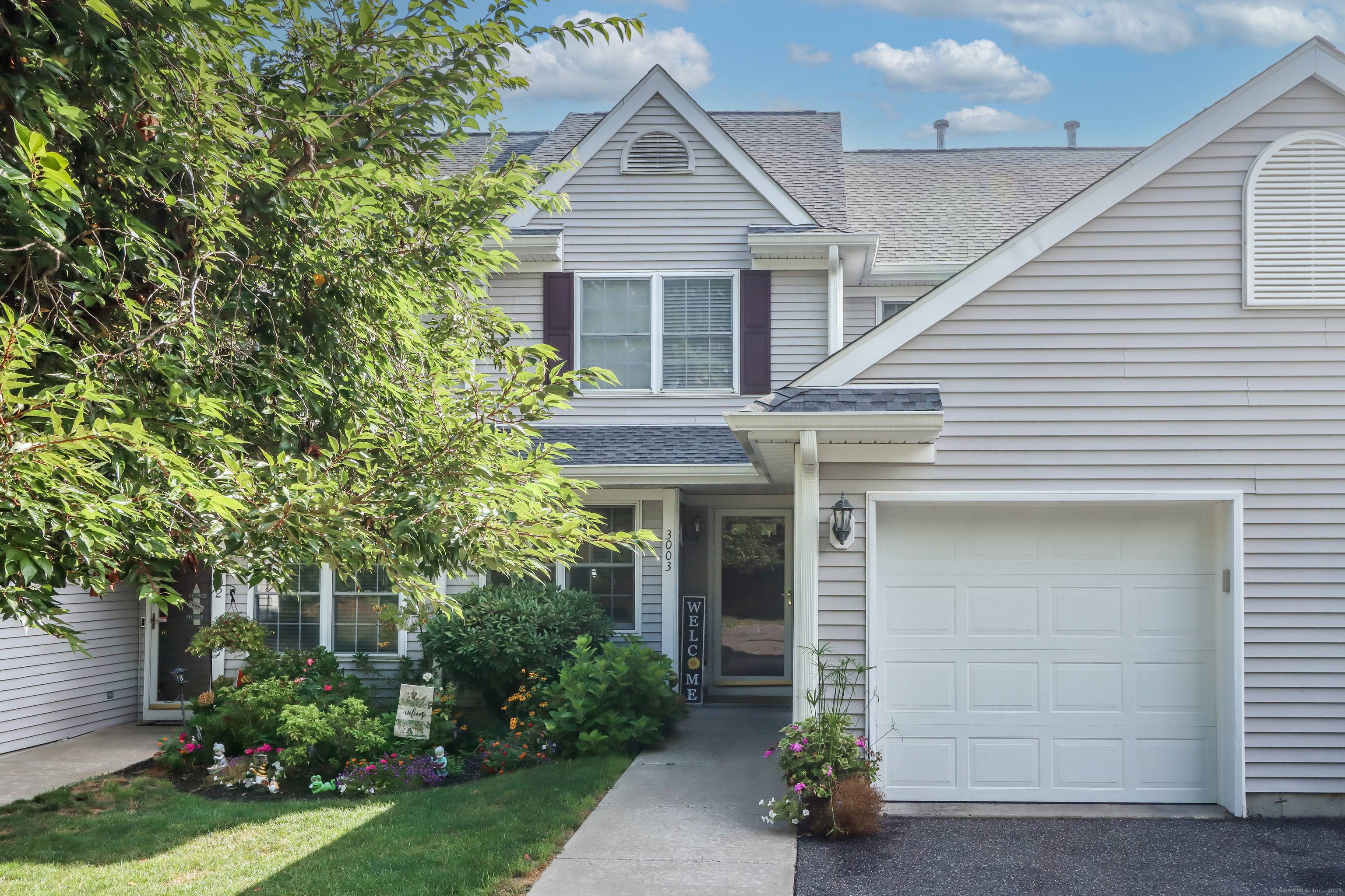 Located in one of Danbury's most desirable communities, this impressive Chestnut model sits at the edge of the complex with a serene preserve backdrop.