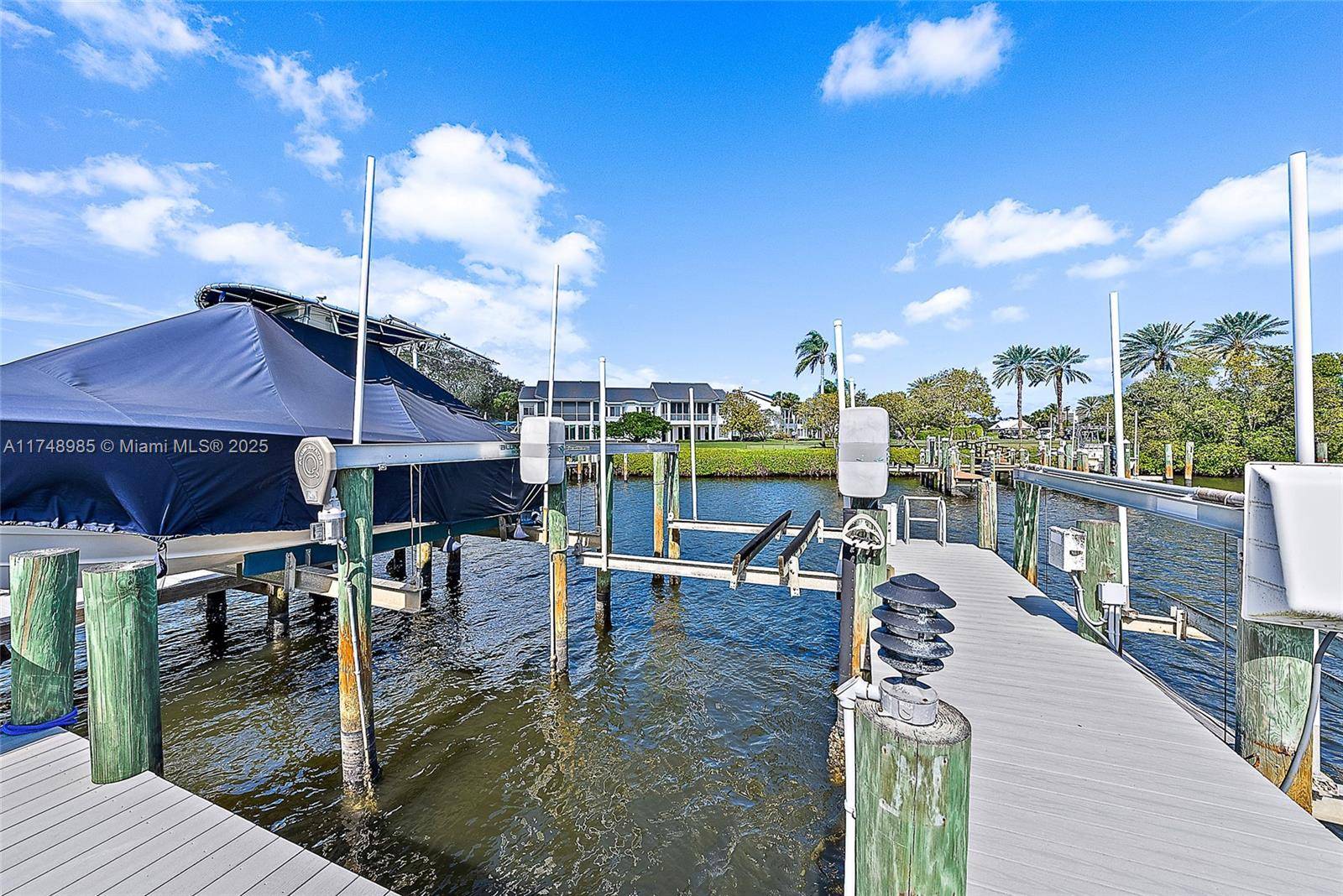 Experience the epitome of waterfront luxury in this first floor Harbor Home on Captains Way, nestled in the prestigious Admirals Cove community.