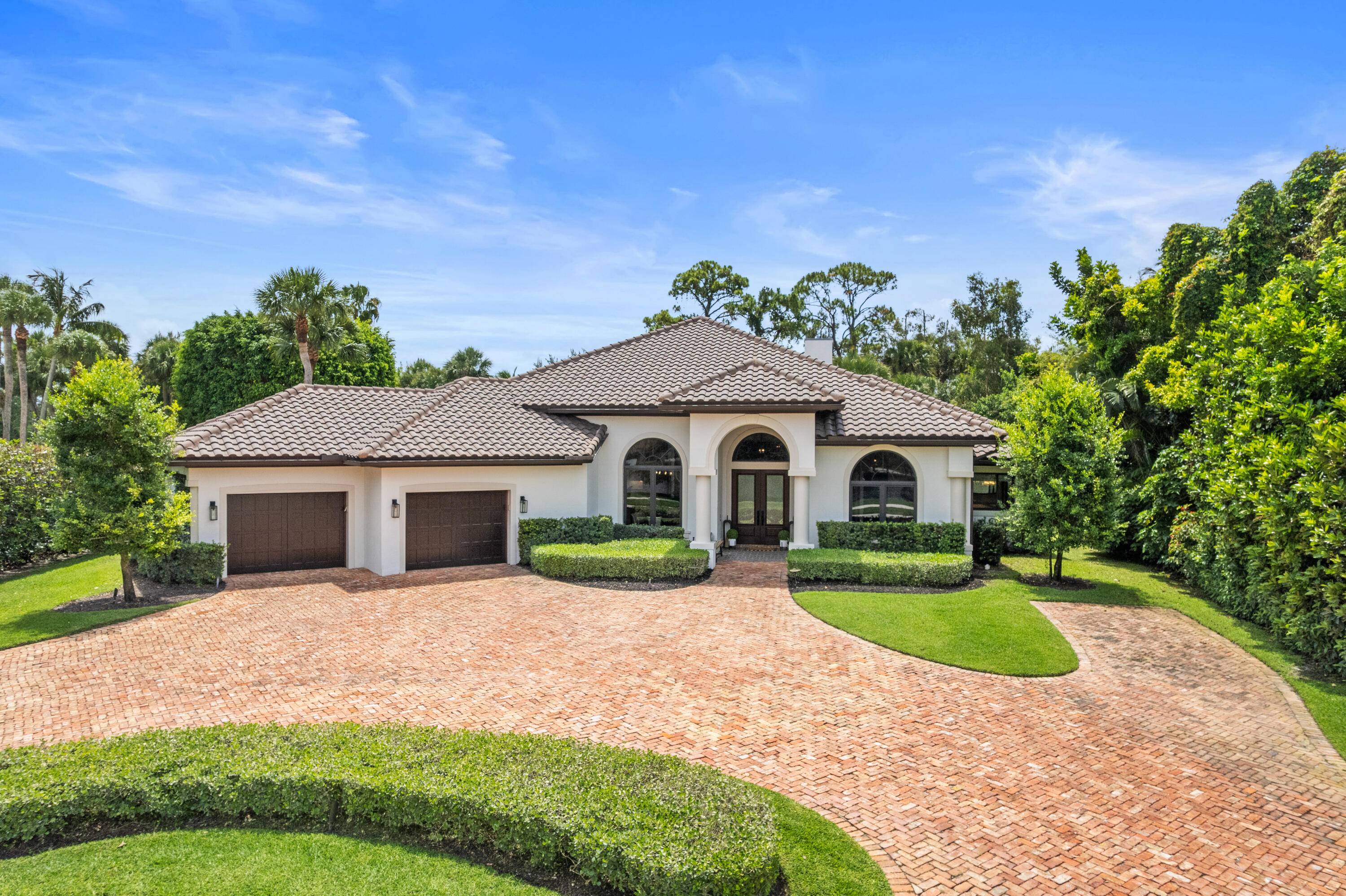 Behind the gates of highly sought after Breakers West is this beautifully renovated custom home that offers the ultimate in indoor outdoor living.