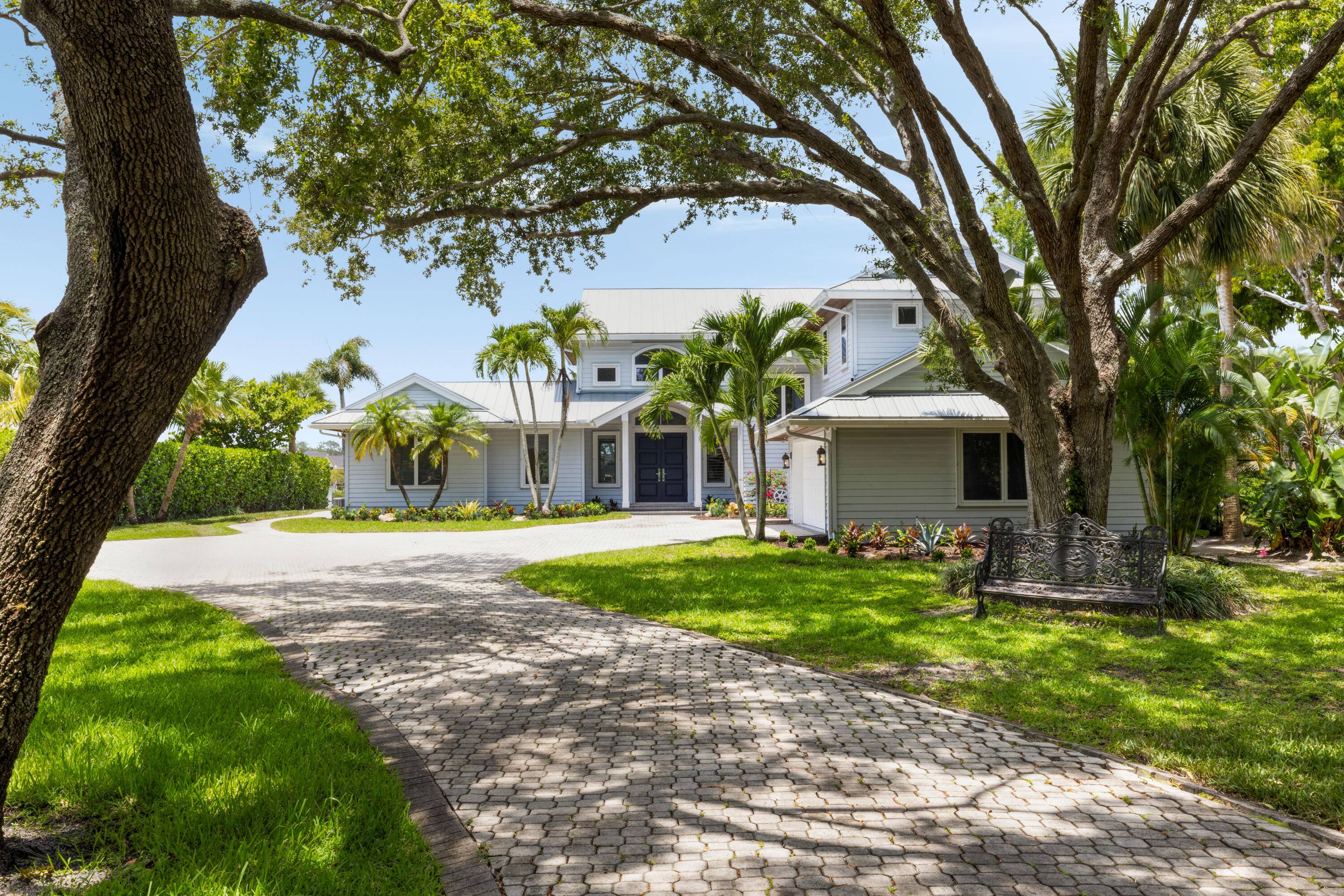 Private Riverfront Estate with Resort Style Pool, Dock Nearly an Acre of LandTucked away behind a gated entry on the scenic Loxahatchee River, this extraordinary waterfront property offers the rare ...